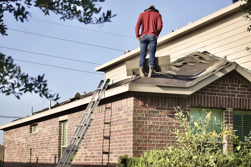 Professional roofer working on a residential roof in Huntley